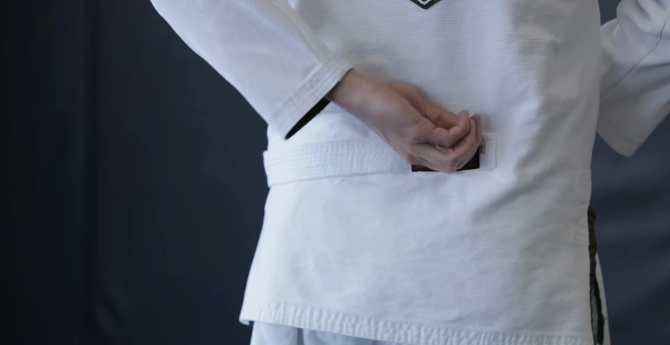 BJJ belt positioned at the back with the tag visible