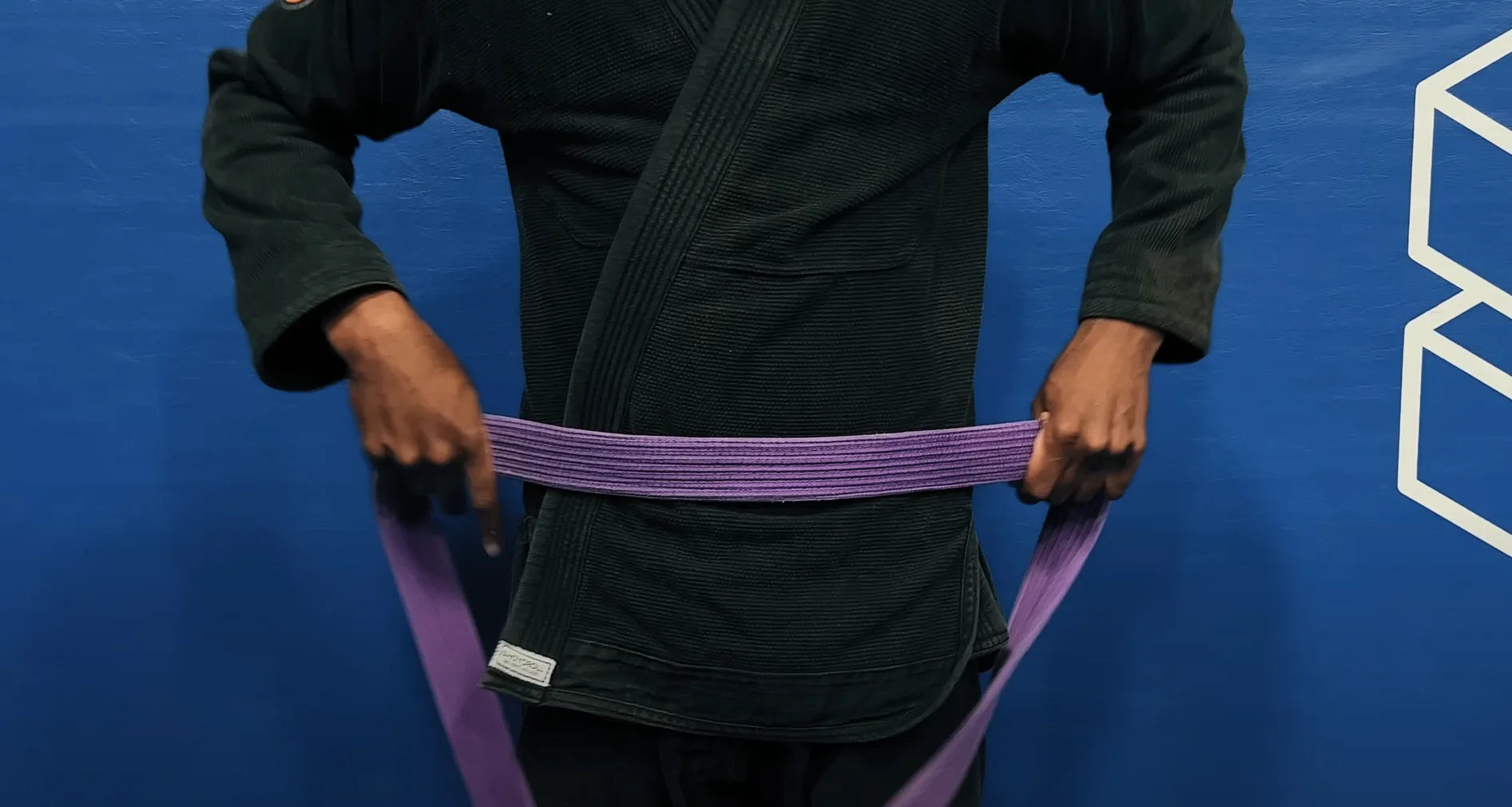 BJJ belt being placed just below belly button